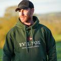 Man wearing a green hoodie with 'Evil Fox' branding in an outdoor setting